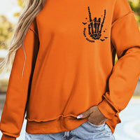 Orange mock neck sweatshirt with 'Spooky Season' ghost graphic, long sleeves