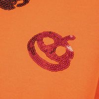 Orange sweatshirt close-up of red sequin mask and critter graphic