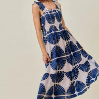 Navy abstract print tiered midi dress with smocked bodice and ruffled cap sleeves
