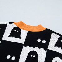 Black checkerboard ghost pattern sweater with orange ribbed collar