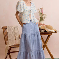Ivory blouse with blue shell print, center-tie front and flutter sleeves