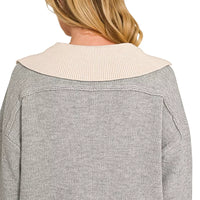 Grey sweater with cream knit back collar and ribbed cuffs, V-neck visible