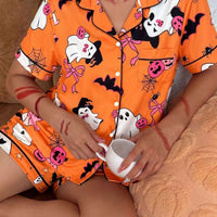 Orange Halloween pajama set: button-front short-sleeve top with ghost and pumpkin prints