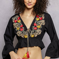 Black cropped blouse with floral embroidery, V-neck tassel cord, and puff sleeves