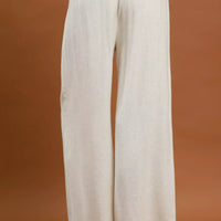 Cream high-waist wide-leg trousers with pleated front and wide straight legs