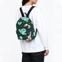 Dark green space-print canvas backpack with black shoulder straps, worn from behind.