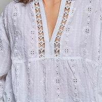 Off-white cotton V-neck blouse with lace-up trim and circular eyelet stitching