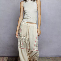 Cream cropped tank top with round neck and lace trim, full-body view
