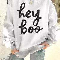 Reversible white mock neck tunic sweatshirt with "hey boo" black script and heart charm detail