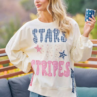 Cream crewneck sweatshirt with stars-and-stripes patch-style graphic, long sleeves