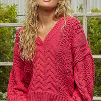 Fuchsia cable-knit cropped V-neck sweater, detailed knit texture and ribbed cuffs