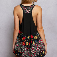 Back of black ribbed tank top with floral woven print patch and open scoop back