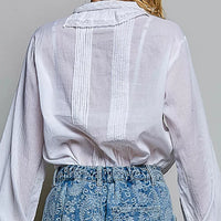 Back view of ivory lace-trim button-down shirt with vertical pintuck panels