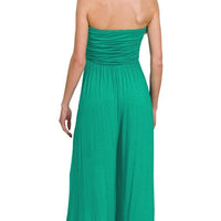 Green strapless jumpsuit with ruched back and flowing tiered skirt