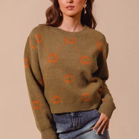 Olive crewneck pumpkin knit sweater with orange rhombus pattern, ribbed hem