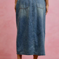 Washed denim midi skirt back view with pleats and patch pockets