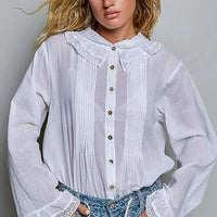 Ivory lace-trim button-down shirt featuring ruffled collar and pintuck button placket