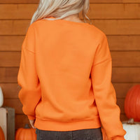 Orange Halloween crewneck sweatshirt back view with ribbed collar and cuffs