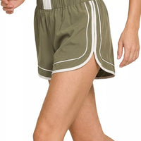 Dusty olive soft woven lined dolphin shorts, curved hem with white border