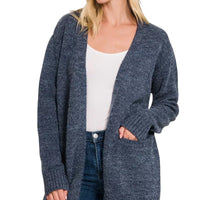 Midnight open-front knit cardigan with front pockets and long sleeves worn over jeans