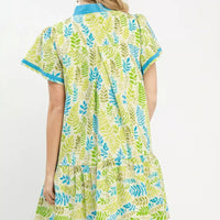 Green and blue leaf print tiered mini dress with flutter sleeves, back view