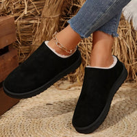 Black suede ankle boots with round toe, plush lining, low-profile outsole, slip-on.