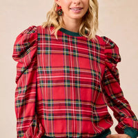 Red plaid top with exaggerated shoulders and balloon sleeves with green ribbed cuffs