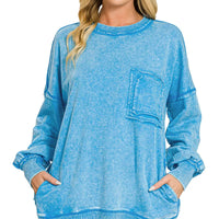 Blue acid-wash French terry sweatshirt with front pocket and raw-edge hemline