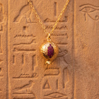 Gold-tone pomegranate charm necklace pendant with purple and pink enamel detail
