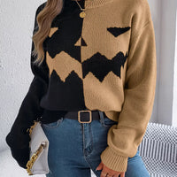 Two-tone knit sweater with pumpkin-face graphic, camel and black, button placket.