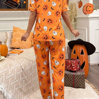 Halloween pajama set: orange button-up top and matching pants with jack-o'-lantern and ghost prints