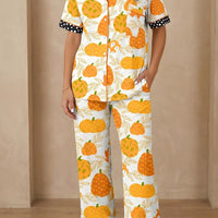 Pumpkin print pajama set with short sleeves and polka-dot trim on cuffs and pant hem