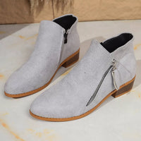 Light gray point-toe block heel ankle boots with side zipper and textured heel