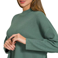 Teal-green crew-neck sweater top with long sleeves and ribbed cuff detail