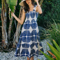 Navy and white abstract print sleeveless midi dress with smocked bodice and tiered skirt