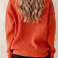 Orange knit sweater with long sleeves and crew neckline, back view