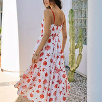 Back view of red-and-white shell print tiered midi cami dress, belted waist, lined