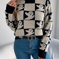 Black and cream ghost checkerboard knit sweater with ribbed hem and long sleeves