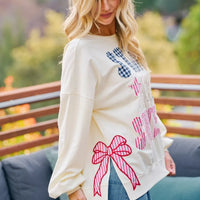 Cream crewneck sweatshirt with stars-and-stripes patch-style graphic and bow detail