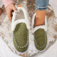 Green faux fur lined round toe slip-on shoes with white fur trim and stitched panels