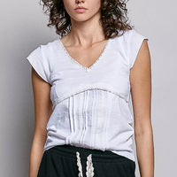 Off-white textured knit V-neck short-sleeve top with lace trim and curved bust panel