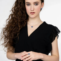 Sapphire pendant necklace on silver chain, blue square pendant at collar