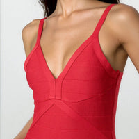 Red bandage dress with deep V-neck and thin straps, contoured seam panels