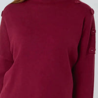 Wine red high-neck jumper back view with button details on sleeves