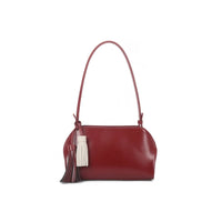 Cherry red faux leather shoulder bag with tassel charms and top handles