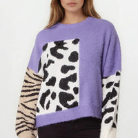 Purple knit jumper with spotted and zebra-striped panels, long sleeves and crew neck