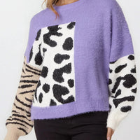 Purple knit jumper with spotted square design and zebra-striped side sleeves