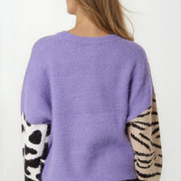 Back view of purple knit jumper with zebra-striped sleeve panels and crew neckline