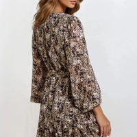 Black spotted mini dress with gathered waist and long sleeves, side view