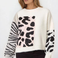 Ivory knit jumper with front spotted graphic, zebra-striped sleeves, and ribbed hem